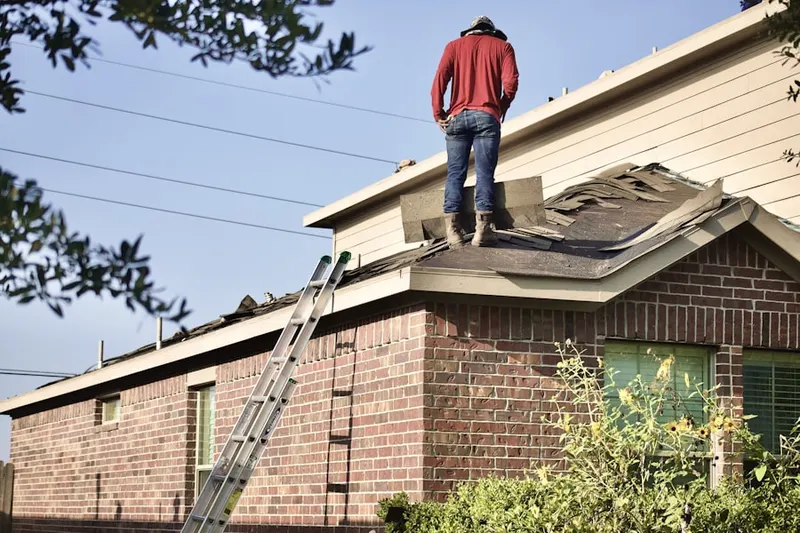 Professional roofer working on a residential roof in Palm Trail